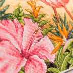 Close-up of a floral pattern with pink flowers and green leaves on a yellow background.