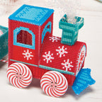 Red toy train with blue roof and peppermint candy wheels on a white background