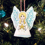 Decorative angel ornament with a star on a Christmas tree.