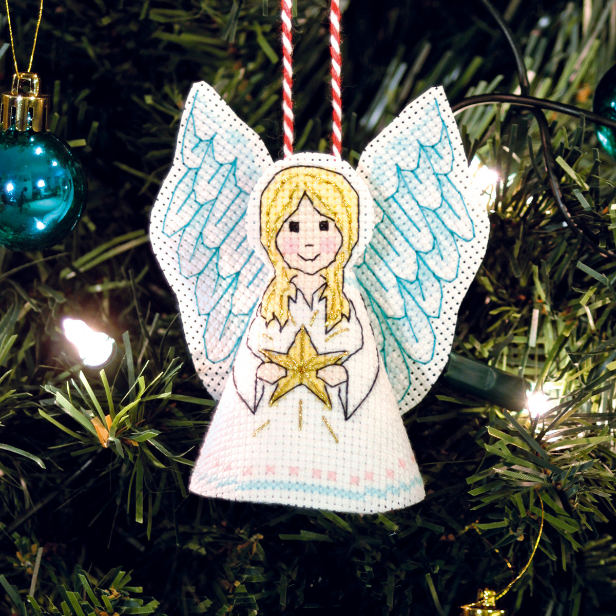 Decorative angel ornament with a star on a Christmas tree.