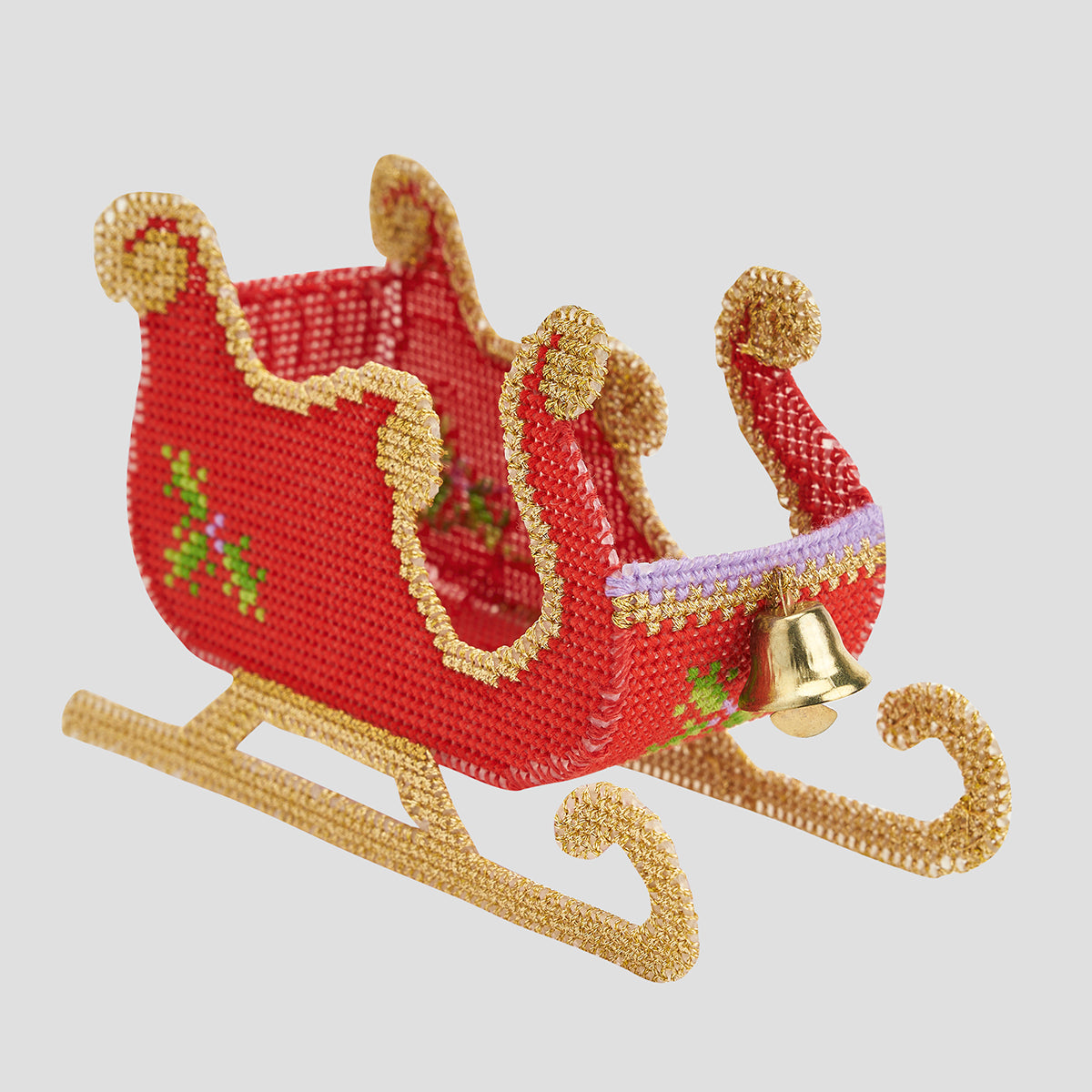 Red and gold beaded sleigh with a bell on a light gray background