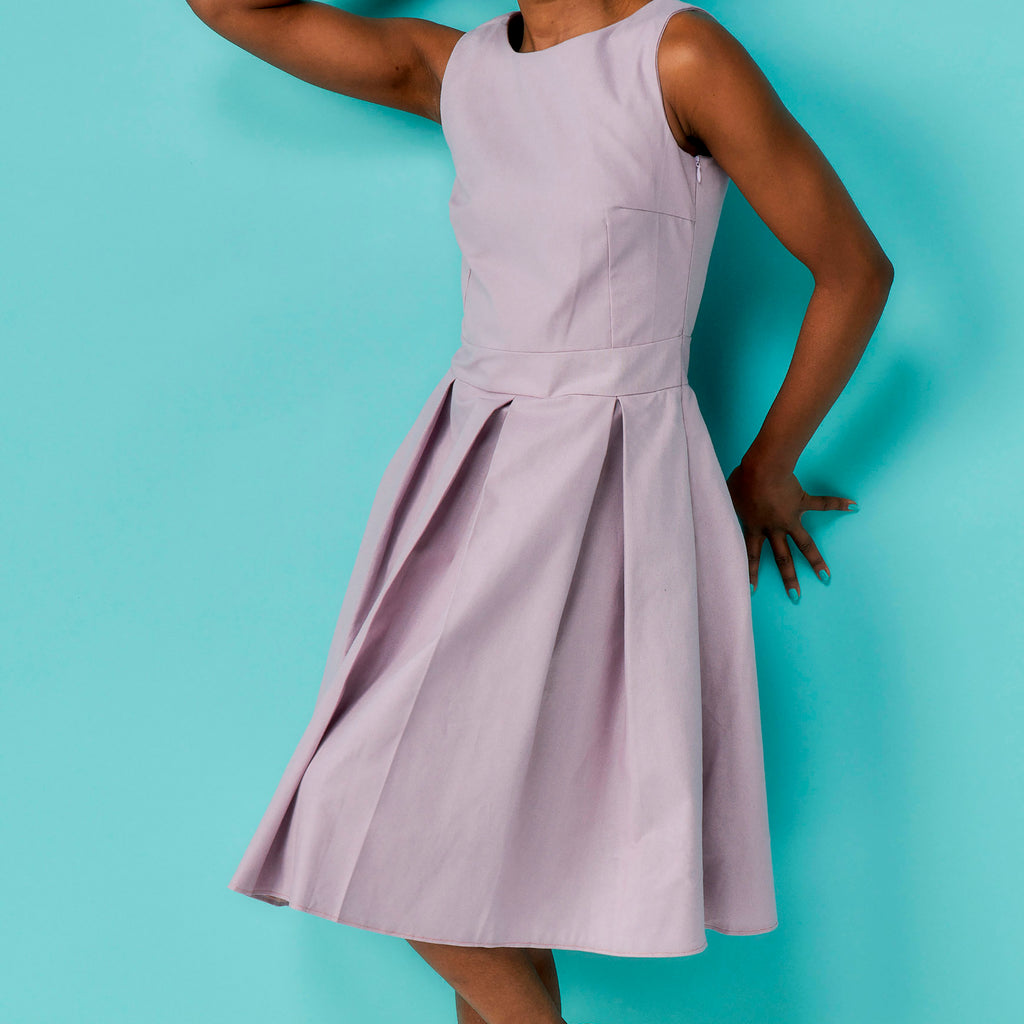 Purple dress worn by a person on a turquoise background