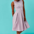 Light purple sleeveless dress worn by a person on a teal background