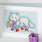 Cross-stitched design of a white fox with presents on a blue background, accompanied by a purple gift box.