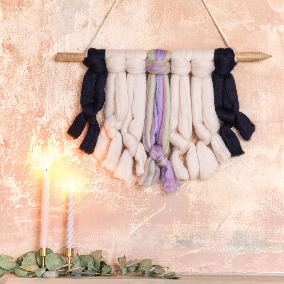 an arm knitted wall hanging