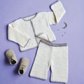 Crocheted baby outfit with cardigan, pants, and shoes on a purple background