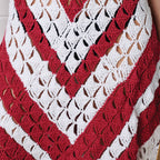 Red and white crocheted garment with a V-neck design.