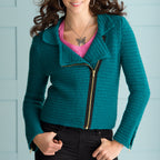 Woman wearing a teal crochet jacket with a zipper against a light blue background