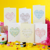 Set of greeting cards with heart designs on a yellow background