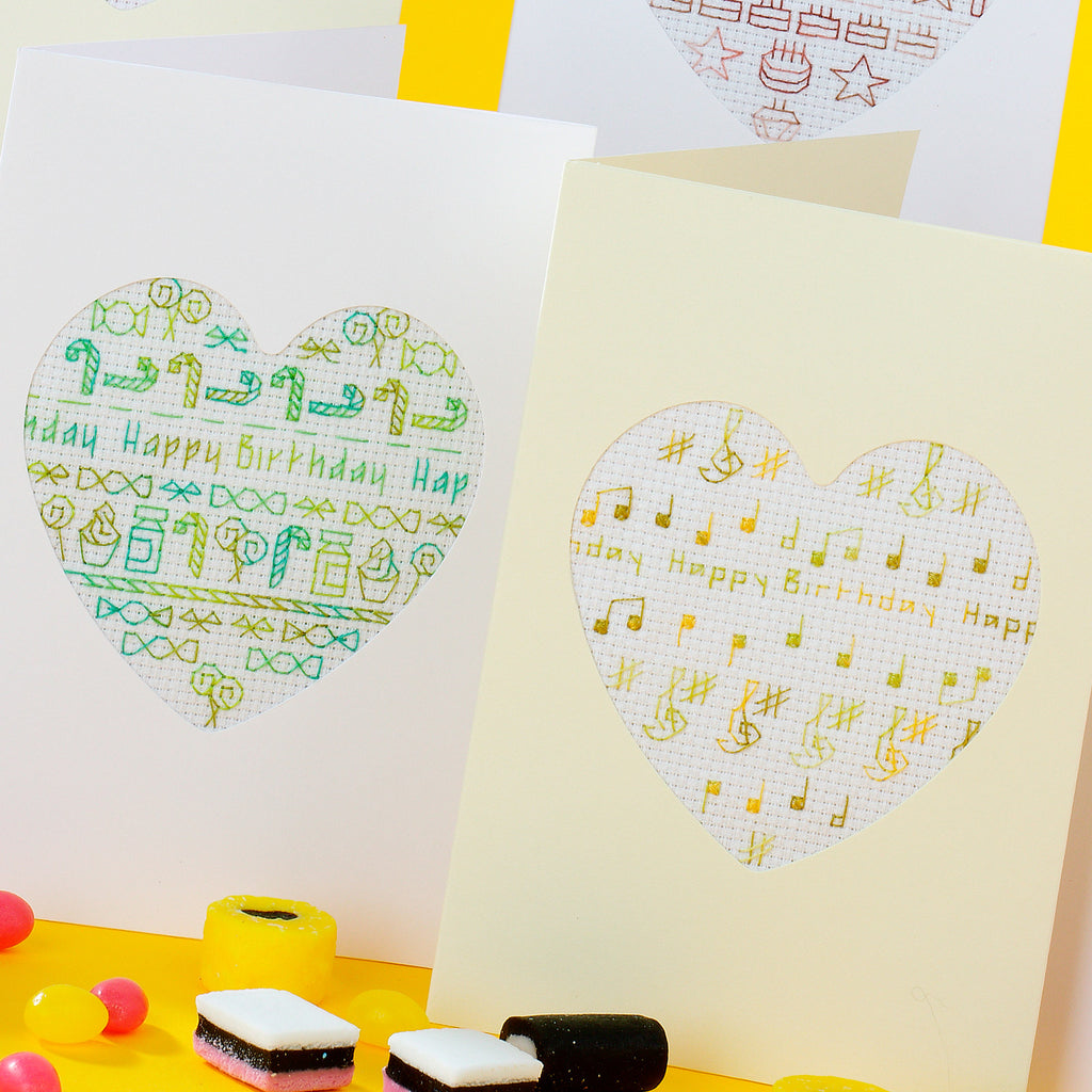 Two greeting cards with heart-shaped 'Happy Birthday' designs on a yellow background.