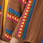 Close-up of a brown knitted garment with colorful边缘
