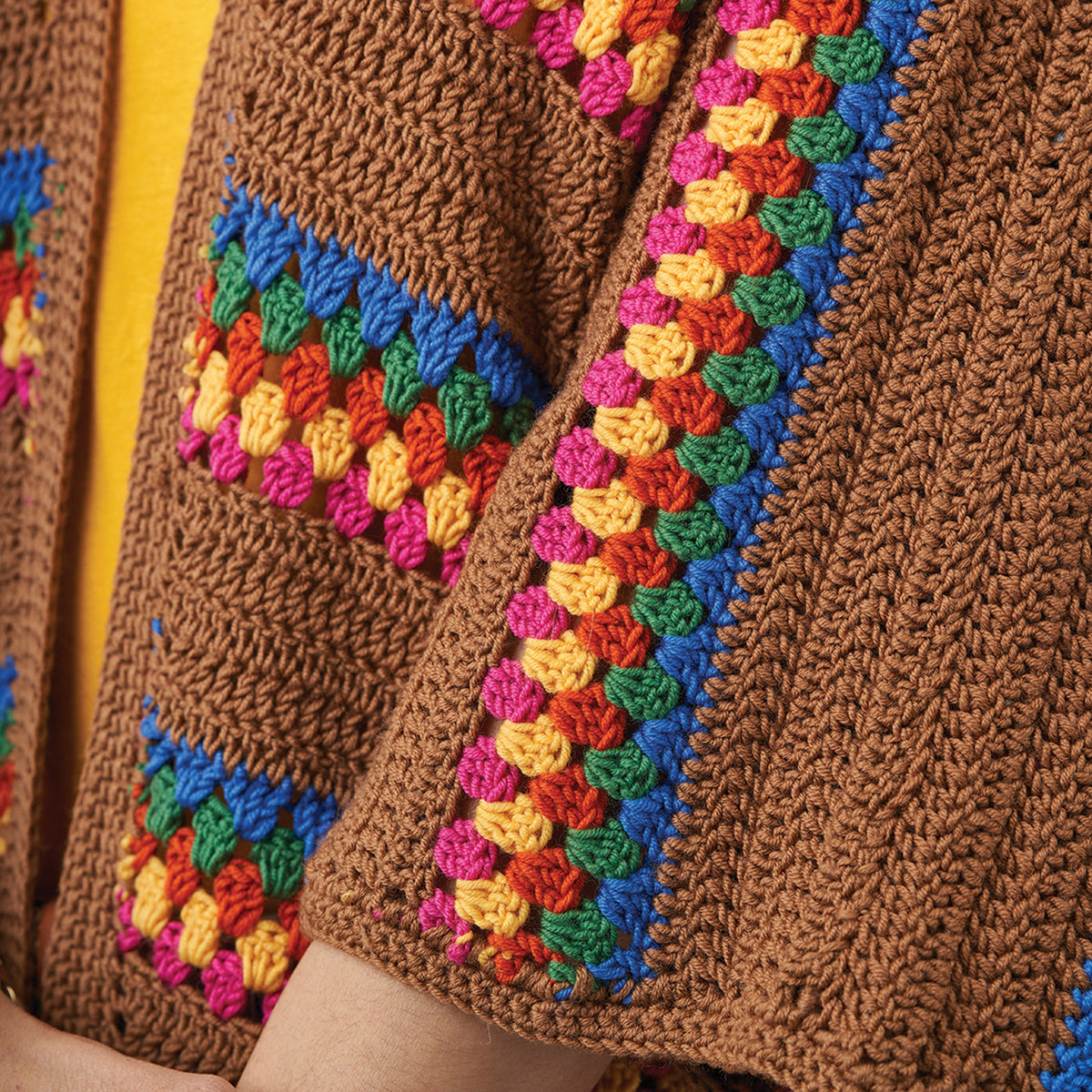 Close-up of a brown knitted garment with colorful边缘