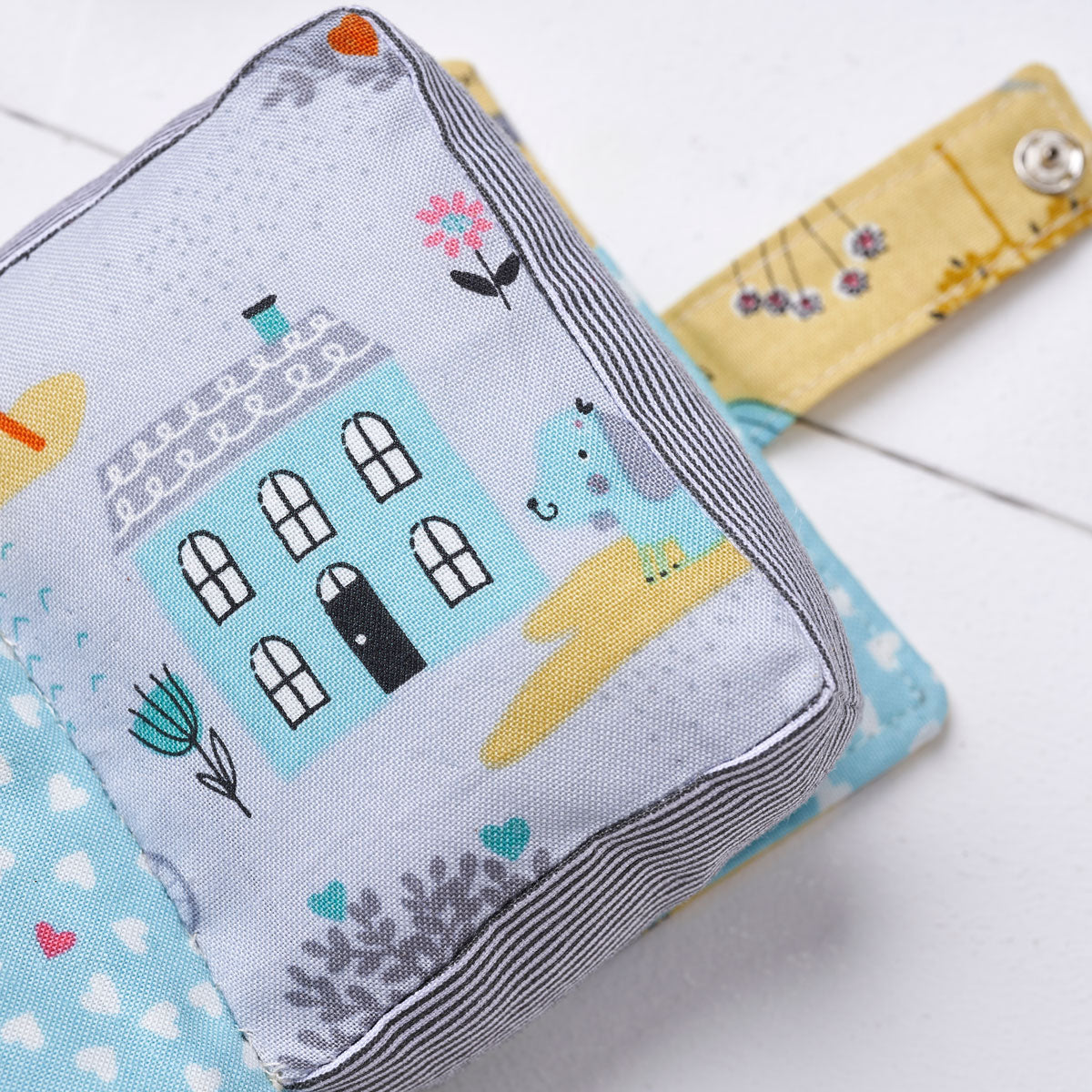 Fabric with house and cat design on a white background