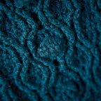 Close-up of teal crocheted fabric texture