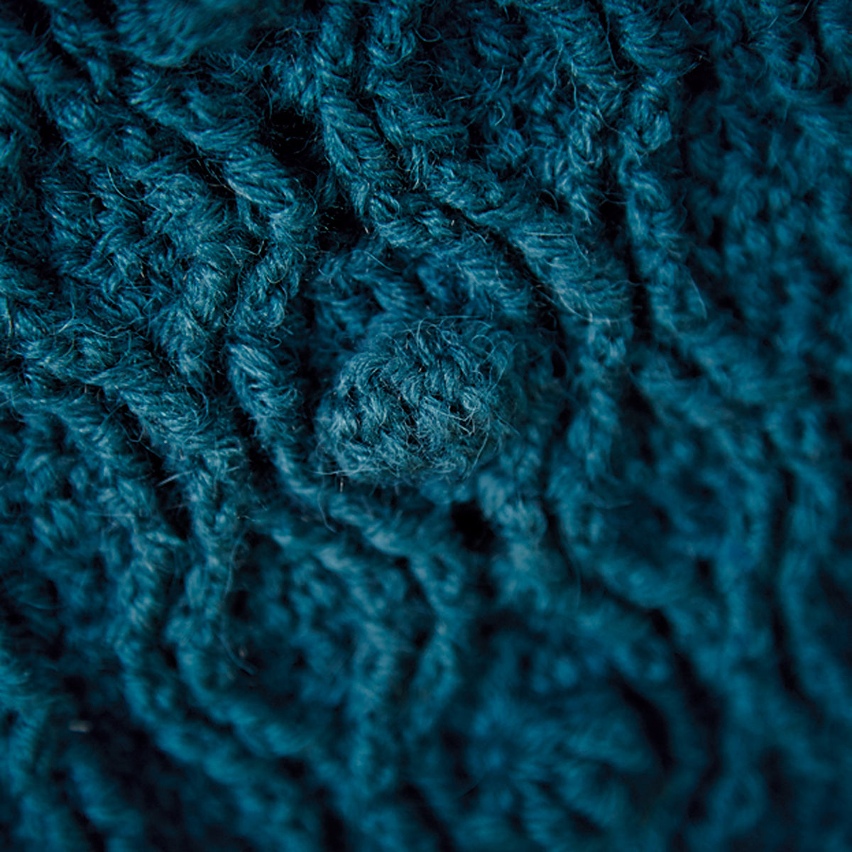 Close-up of teal crocheted fabric texture