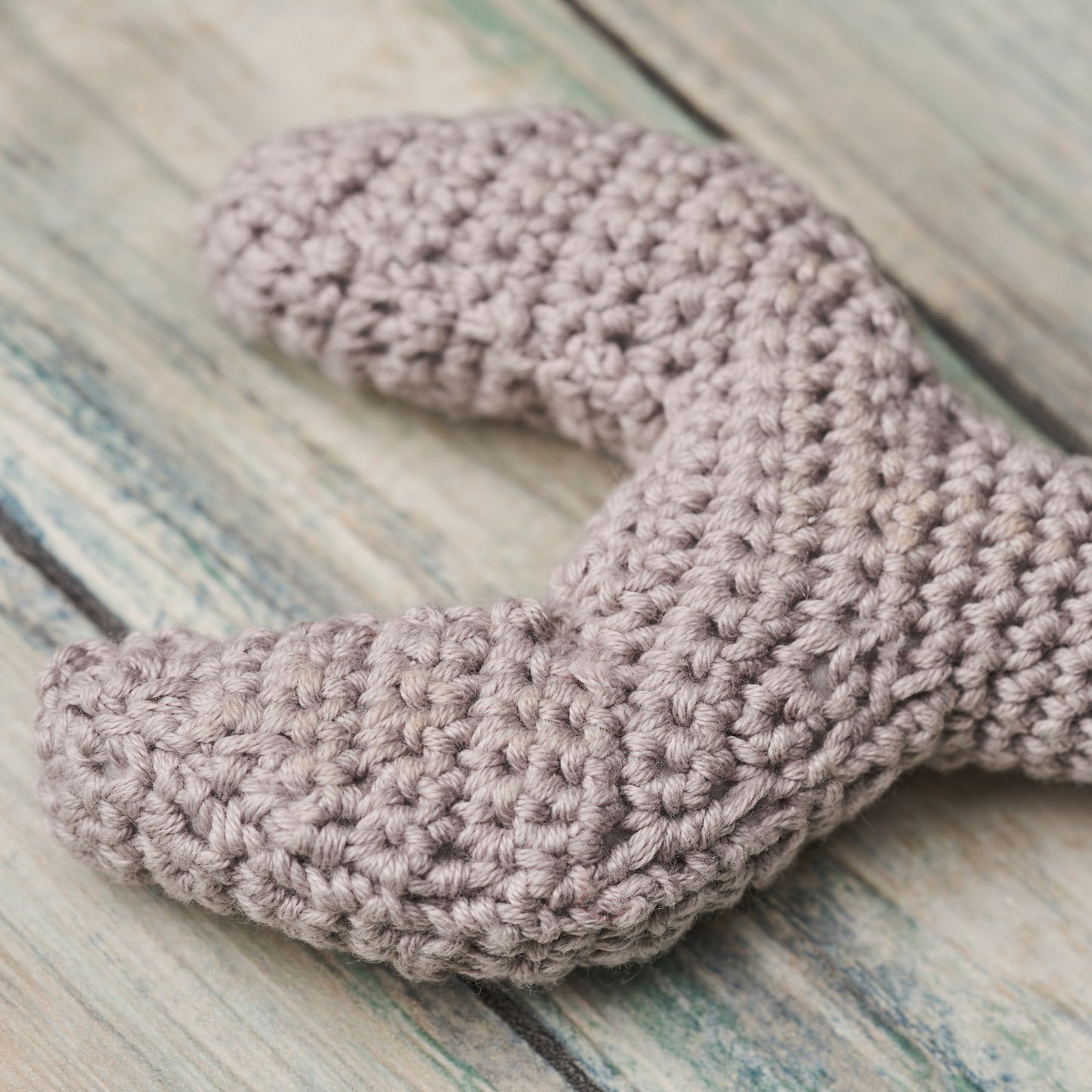 Crocheted spanner on a wooden surface