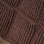 Close-up of brown textured fabric with a diamond pattern