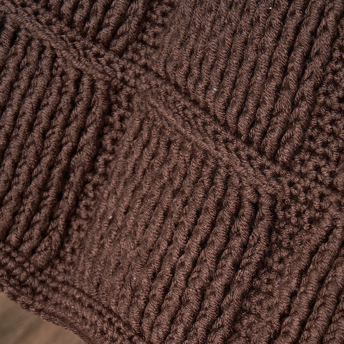 Close-up of brown textured fabric with a diamond pattern
