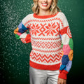 Person wearing a colorful patterned sweater with a green background