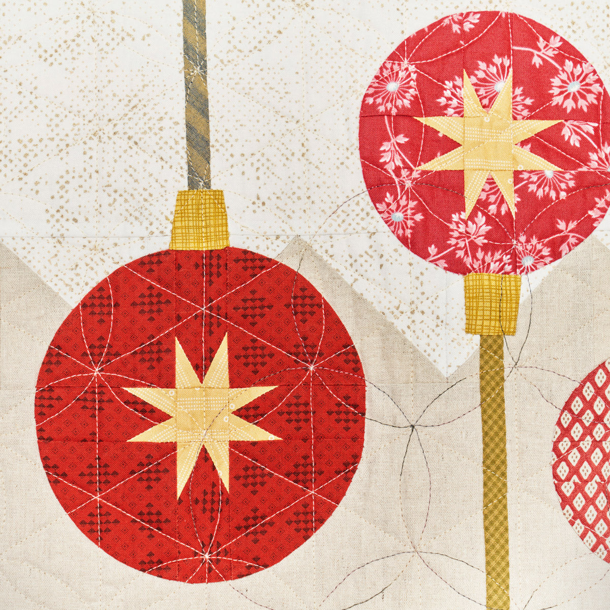 Decorative red ornaments with gold stars on a textured beige background