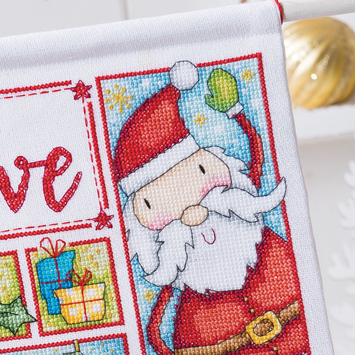 Cross-stitched design of Santa Claus with a white background