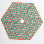 Hexagonal tree skirt with red and white pattern on a green background