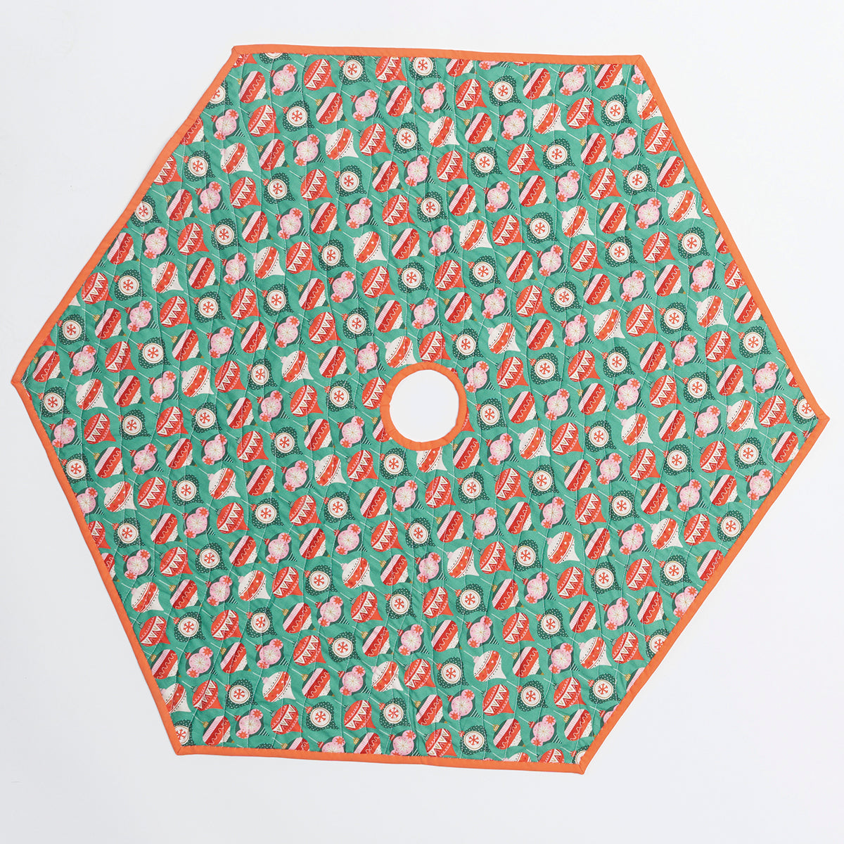 Hexagonal tree skirt with red and white pattern on a green background
