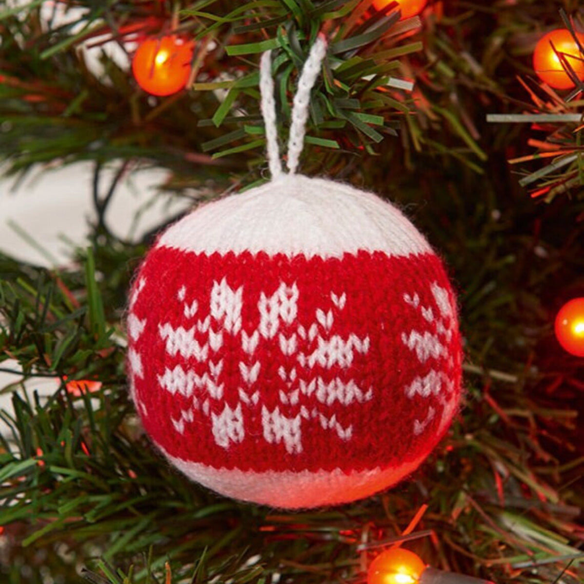 Knitted Christmas bauble hanging in a tree