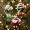 Knitted fairy ornaments on a Christmas tree with lights.