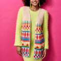 Woman wearing a colorful patterned scarf against a pink background
