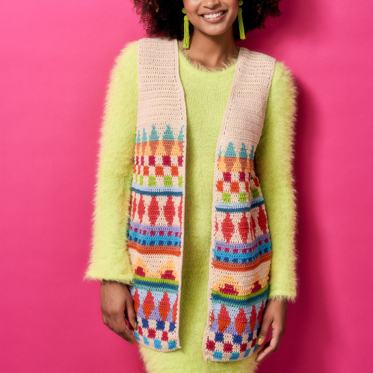 Woman wearing a colorful patterned scarf against a pink background