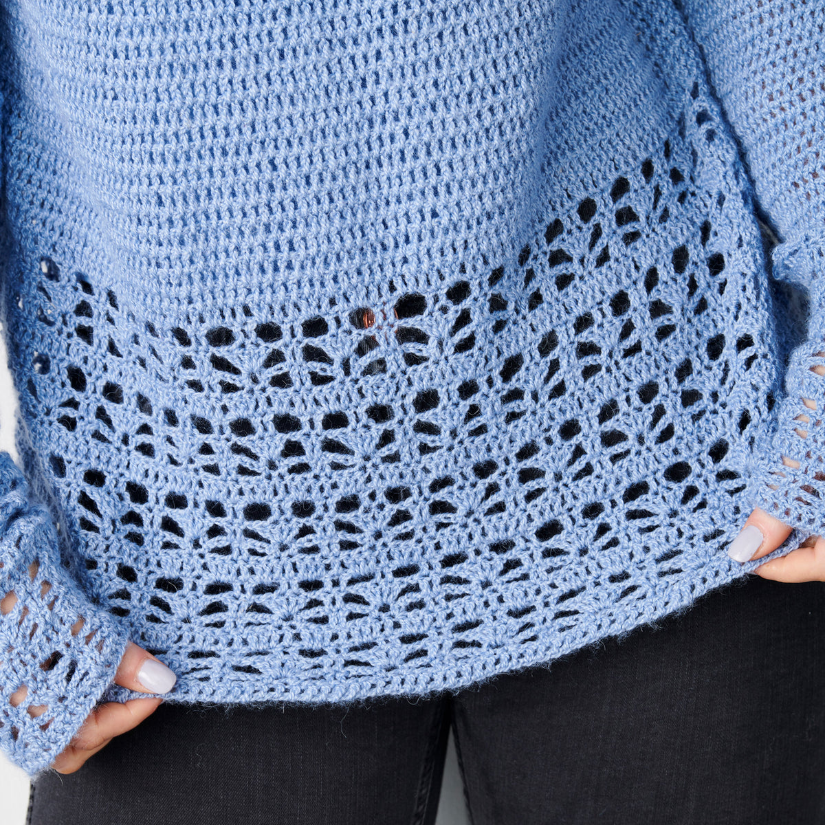 Close-up of a blue crochet garment with intricate pattern