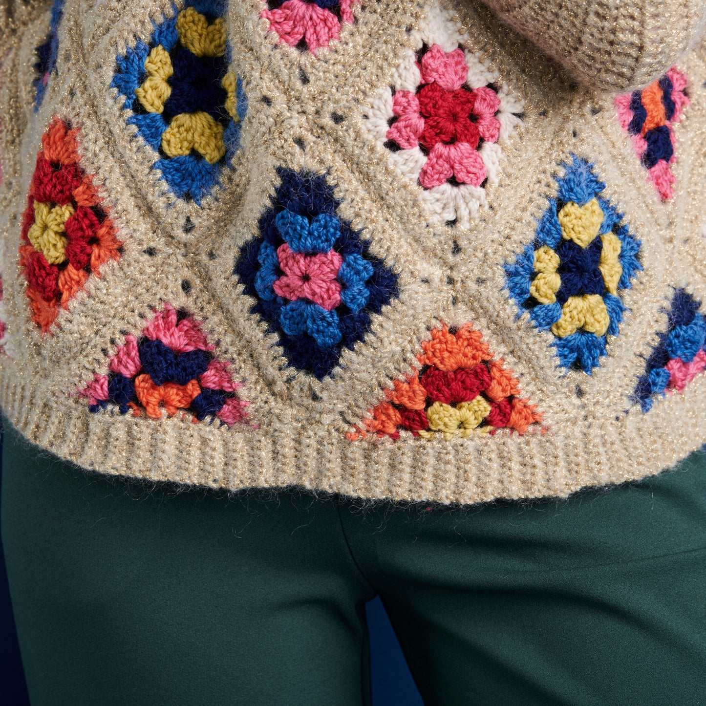 Close-up of a colorful crochet pattern on a garment.