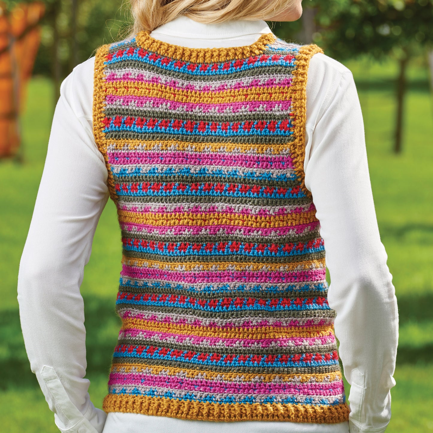 Colorful striped crochet vest worn by a person outdoors