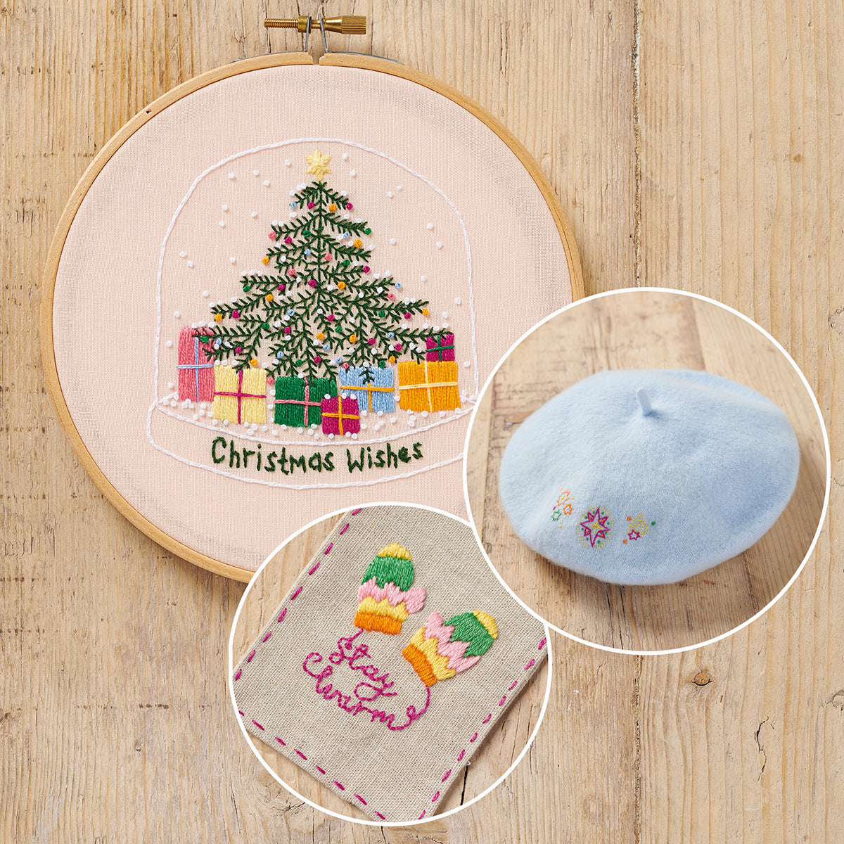 Embroidery hoop with Christmas-themed embroidery, small blue beret, and fabric patch on a wooden surface.