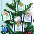 Decorative Christmas tags with festive designs on a Christmas tree.