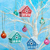 Decorative birdhouse ornaments hanging on a white branch against a blue background