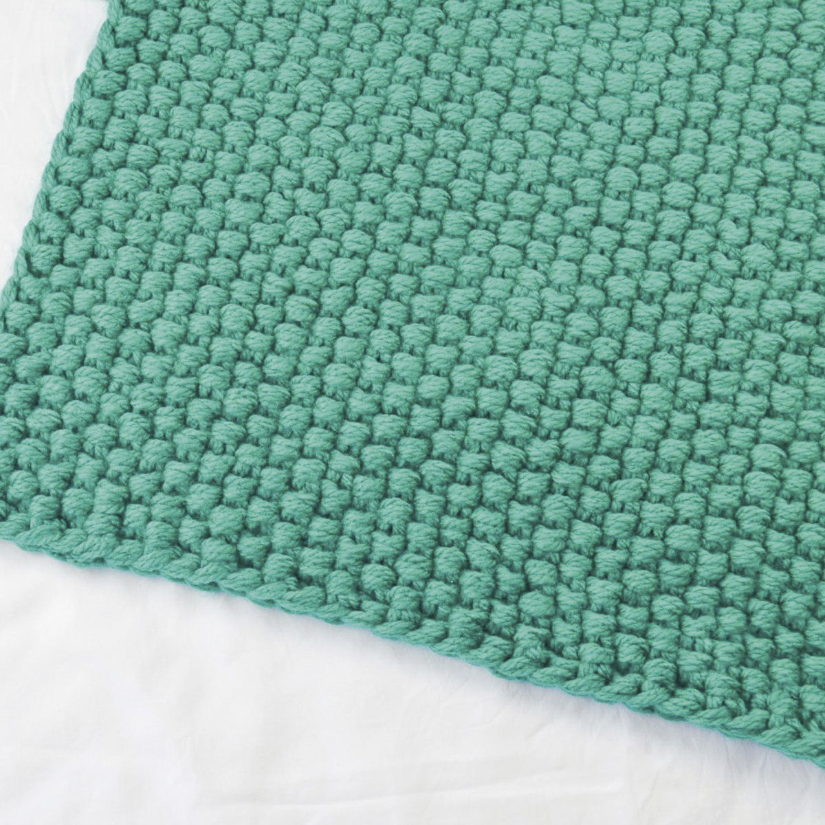 A closeup of the moss stitch used in a  floor cushion knitting pattern 