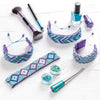 Makeup brushes, nail polish, and decorative headbands on a white background