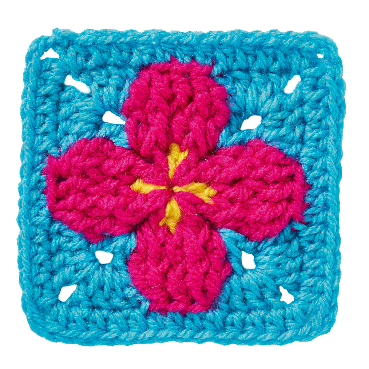Crocheted square with a pink flower design on a blue background