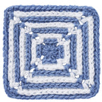 Blue and white crocheted square pattern on a white background