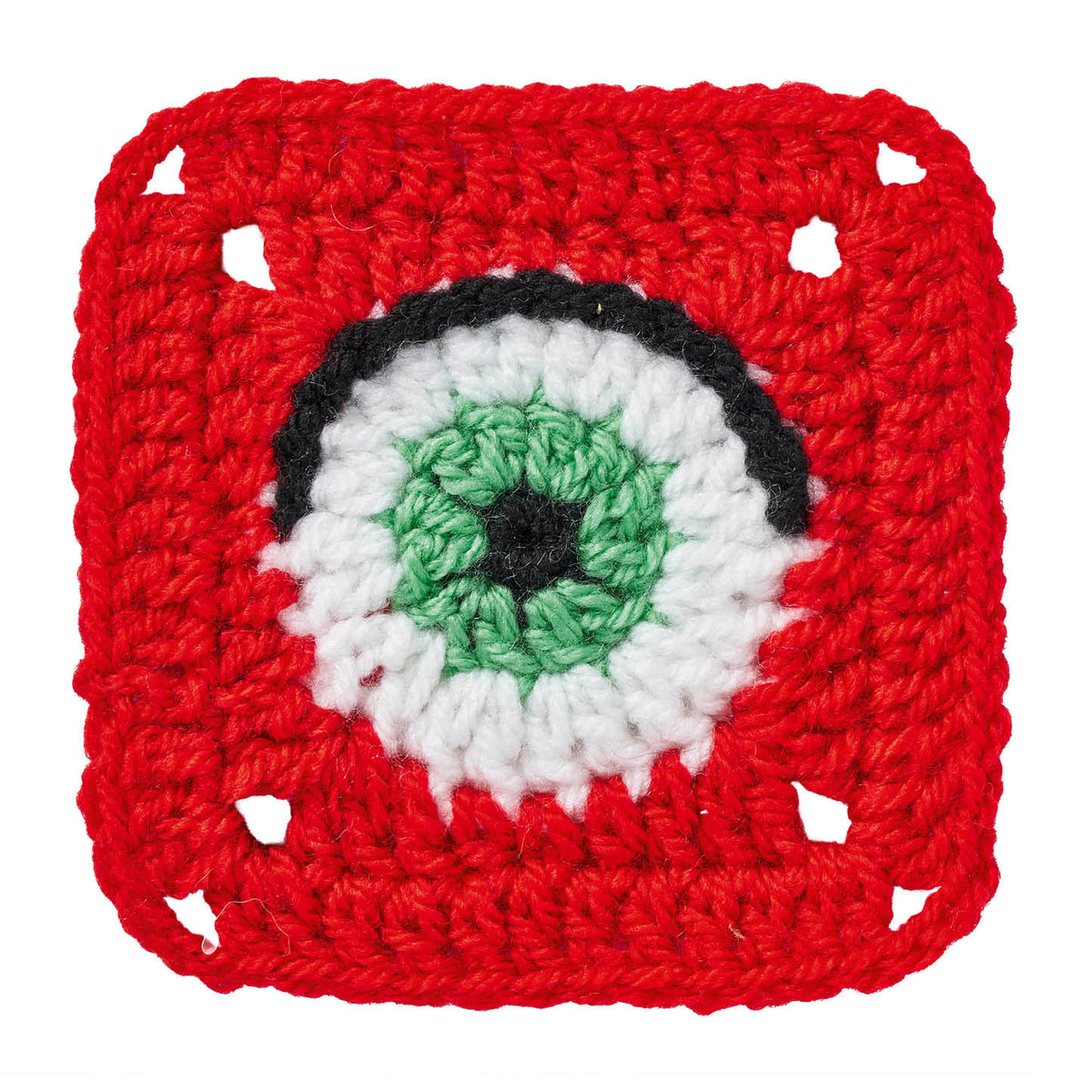 Crocheted square with a central eye design on a white background