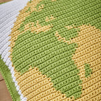 Close-up of a knitted fabric with green and yellow pattern