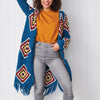 Person wearing a colorful crochet cardigan with geometric patterns on a white background