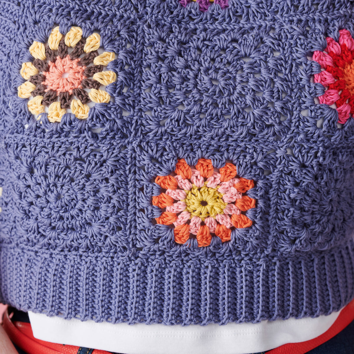Blue crochet fabric with colorful flower patterns