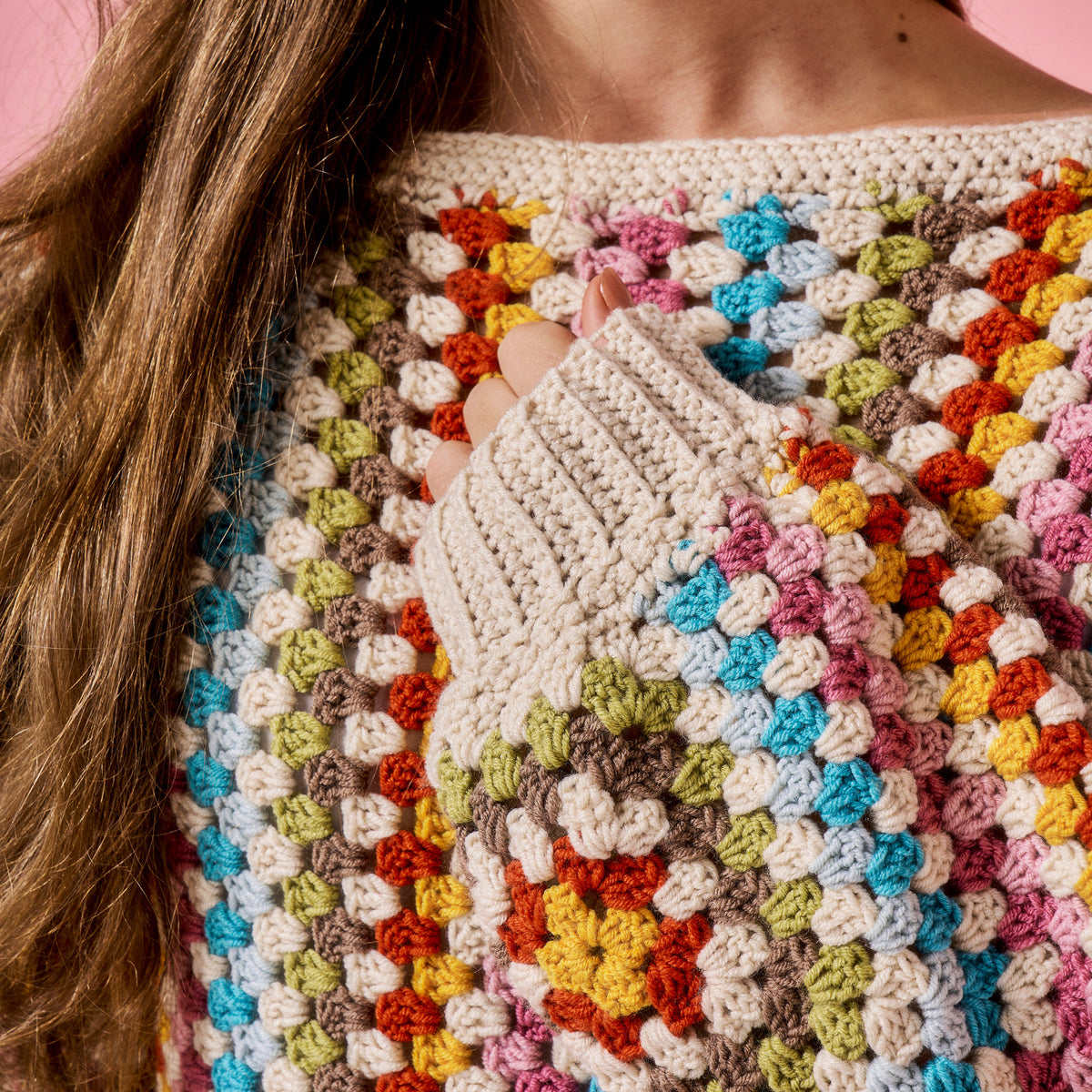 Close-up of a colorful crochet garment with a patterned design.