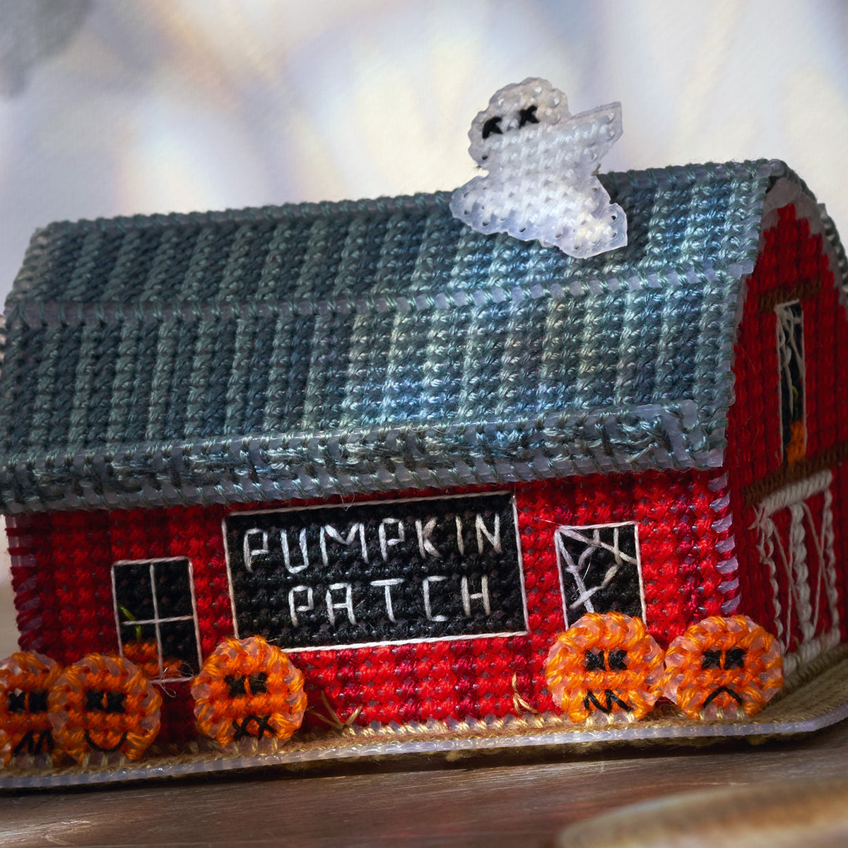 Decorative 3D cross stitch with pumpkins and 'Pumpkin Patch' text on a blurred background