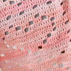 Close-up of a pink textured fabric with black and white speckles