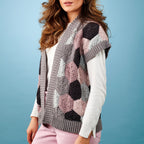 Woman wearing a patterned crochet vest against a blue background