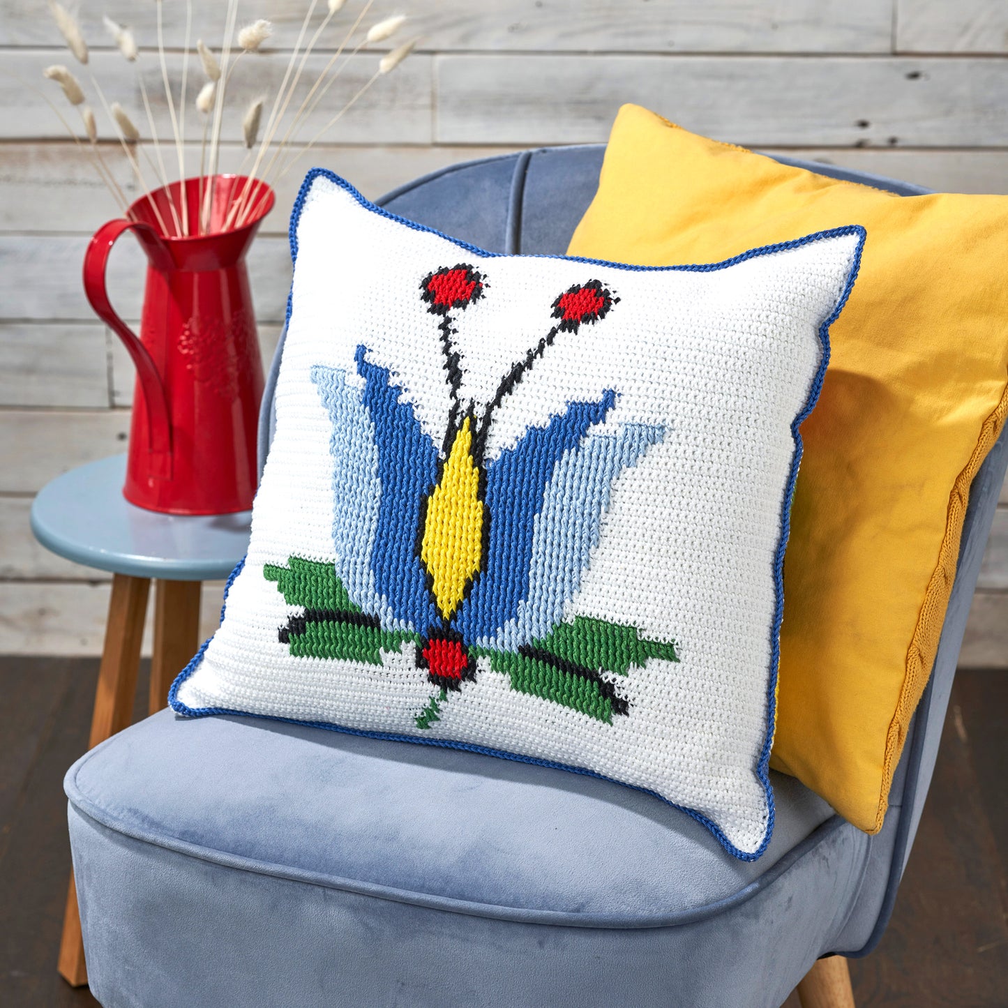 Decorative pillow with a floral pattern on a blue chair